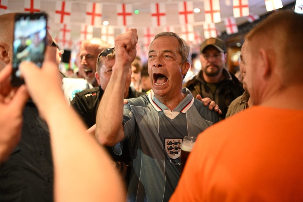 Leader of Reform UK Nigel Farage wearing a 1996 England football shirt joins England football fans watching a live broadcast of the UEFA Euro 2024 Group C football match between Denmark and England