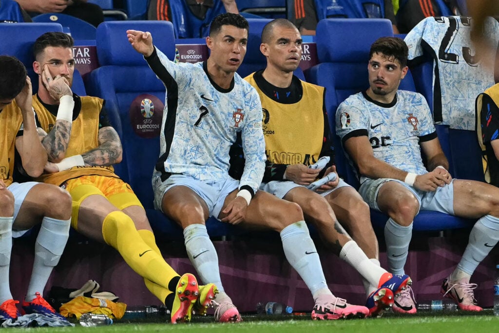 Portugal's forward #07 Cristiano Ronaldo reacts from the bench next to Portugal's defender #03 Pepe and Portugal's midfielder #25 Pedro Neto during the UEFA Euro 2024 Group F football match between Georgia and Portugal at the Arena AufSchalke in Gelsenkirchen on June 26, 2024.