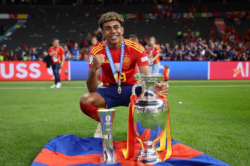 Lamine Yamal poses for a photo Best Young Player trophy and the UEFA Euro 2024 Henri Delaunay Trophy after Spain beat England in the final.