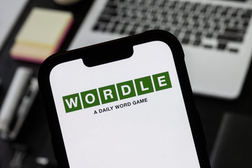 In this photo illustration, a Wordle logo seen displayed on