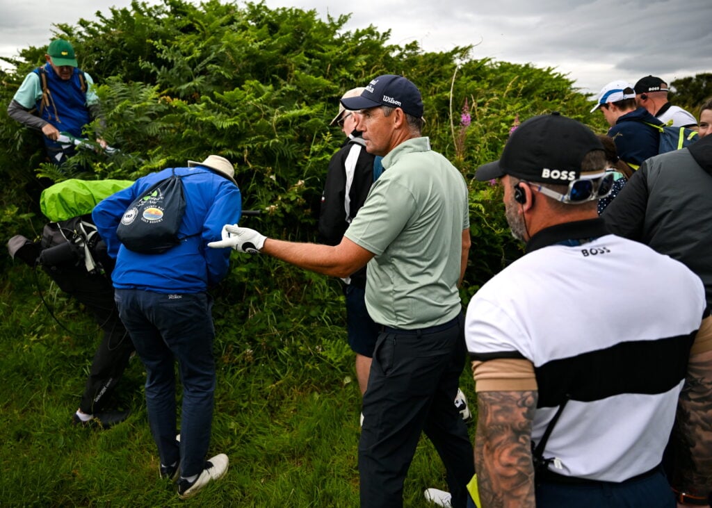 Padraig Harrington looks for his ball on the 11th hole during the first round of The Open Championship