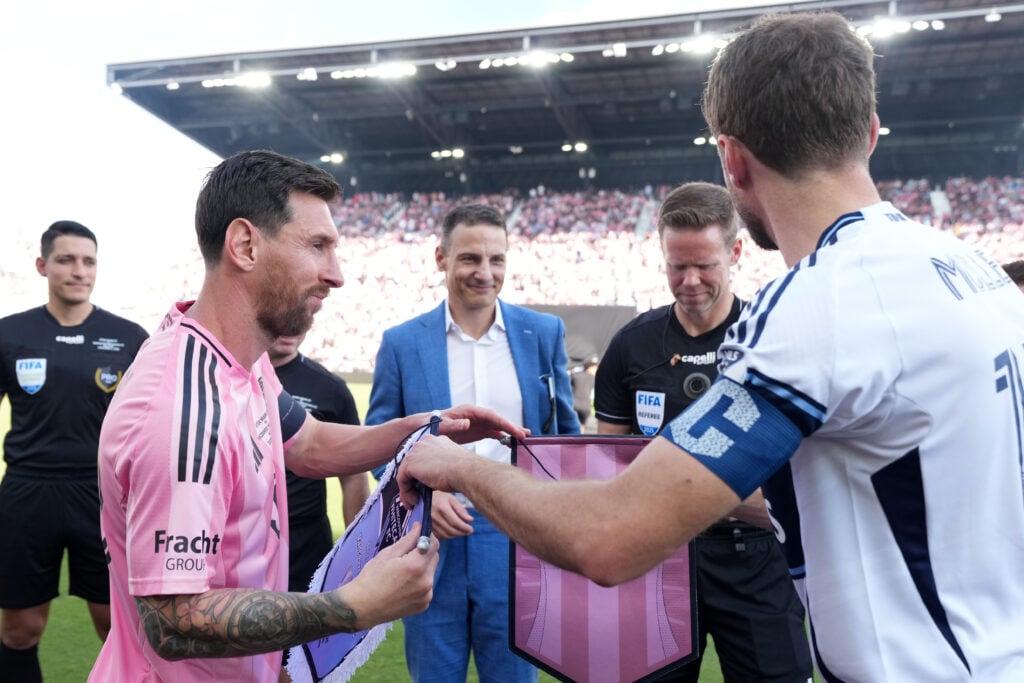 Lionel Messi #10 of Inter Miami CF switches the match pennant with Thomas Muller #13 of the Vancouver Whitecaps FC prior to the Audi 2025 MLS Cup Final match between Inter Miami CF and Vancouver Whitecaps FC at Chase Stadium on December 06, 2025 in Fort Lauderdale, Florida.
