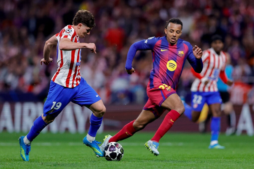Julian Alvarez of Atletico Madrid and Jules Kounde of FC Barcelona battle for the ball during the UEFA Champions League 2025/26 Quarter-Final Second Leg match between Club Atlético de Madrid and FC Barcelona at Riyadh Air Metropolitano on April 14, 2026 in Madrid, Spain.