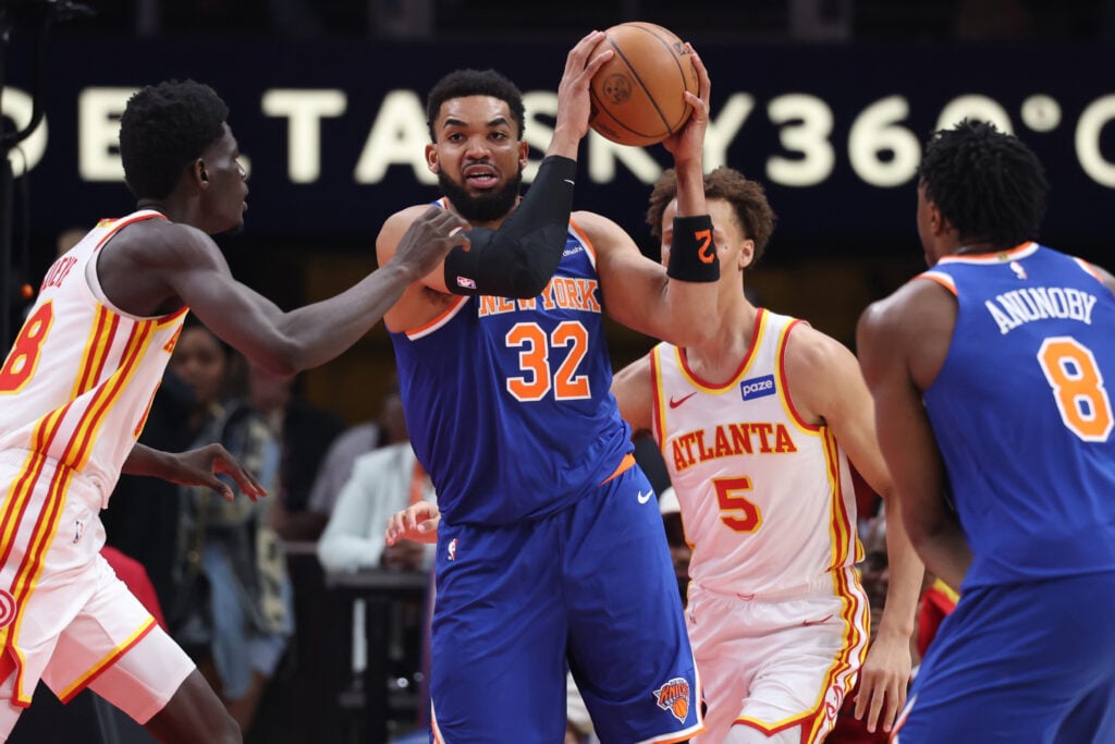 Karl-Anthony Towns #32 of the New York Knicks works against Mouhamed Gueye #18 of the Atlanta Hawks during the first quarter in Game Six of the First Round of the NBA Eastern Conference Playoffs at State Farm Arena.