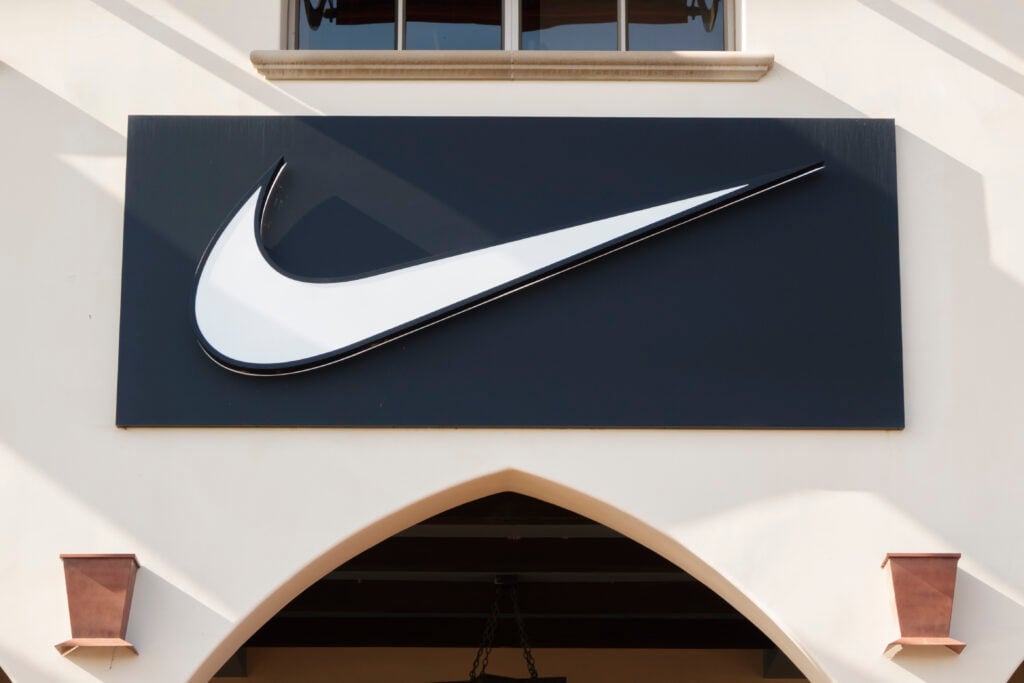 A Nike logo is displayed on a sign outside of a store.