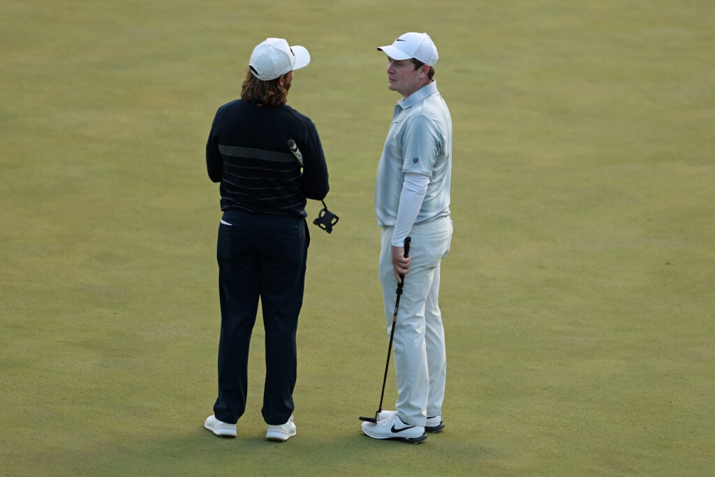 Tommy Fleetwood and Robert MacIntyre talk on the 18th green during the first round of the PGA Championship at Aronimink