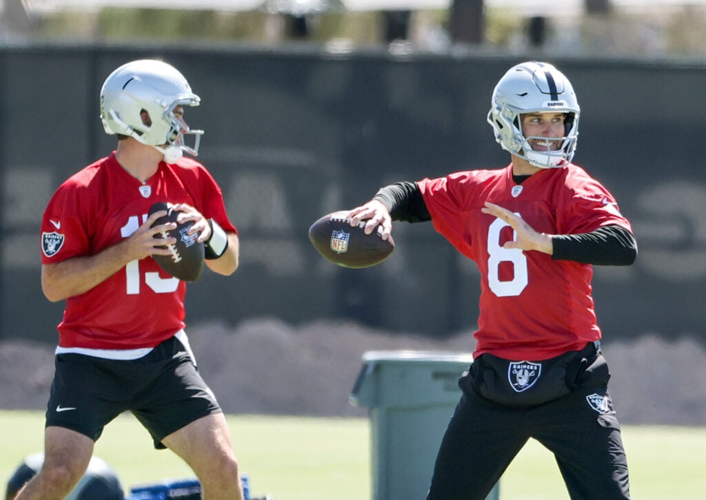 Quarterbacks Fernando Mendoza #15 and Kirk Cousins #8 of the Las Vegas Raiders practice during an OTA offseason workout at the Las Vegas Raiders Headquarters/Intermountain Health Performance Center.