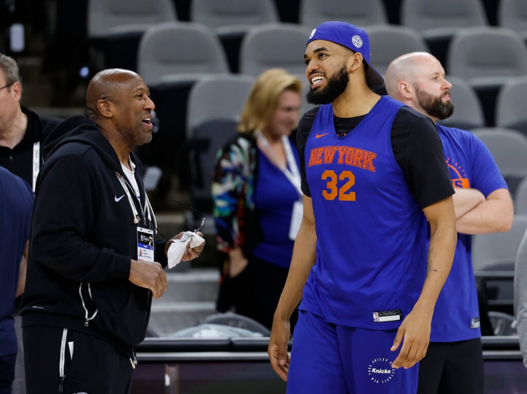 Head coach Mike Brown and Karl-Anthony Towns #32 of the New York Knicks joke during 2026 NBA Finals - Media Day at Frost Bank Center.