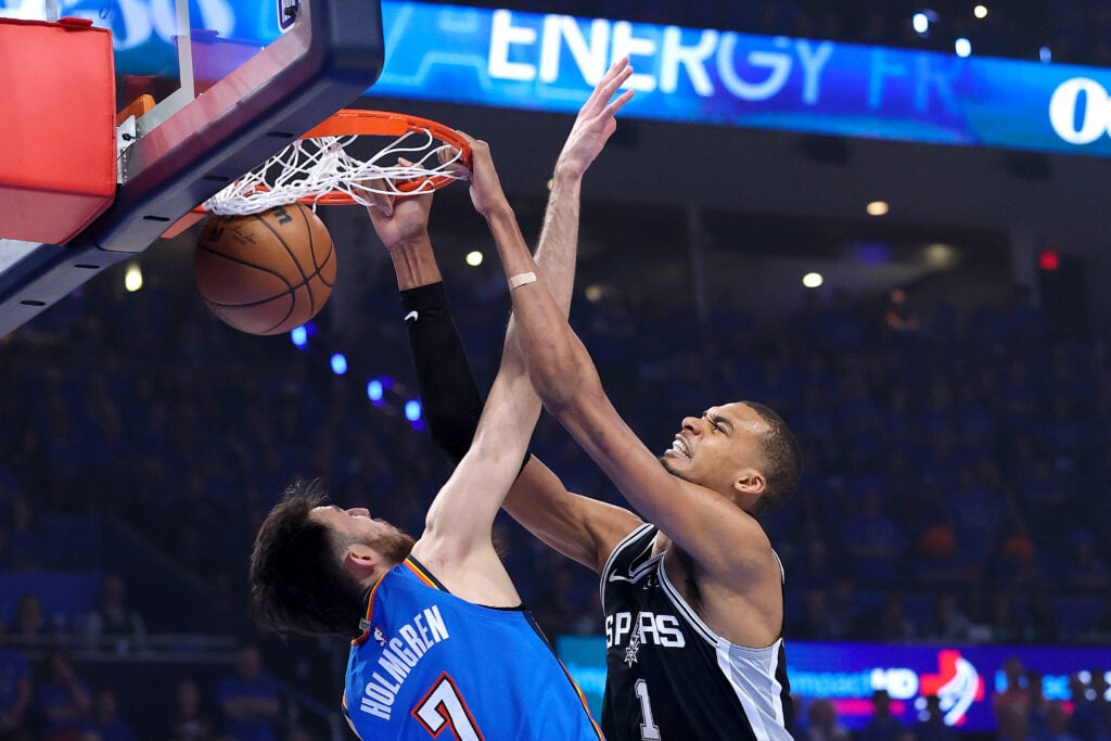 Victor Wembanyama #1 of the San Antonio Spurs dunks the ball against Chet Holmgren #7 of the Oklahoma City Thunder during the first quarter in Game Seven of the NBA Western Conference Finals at Paycom Center.
