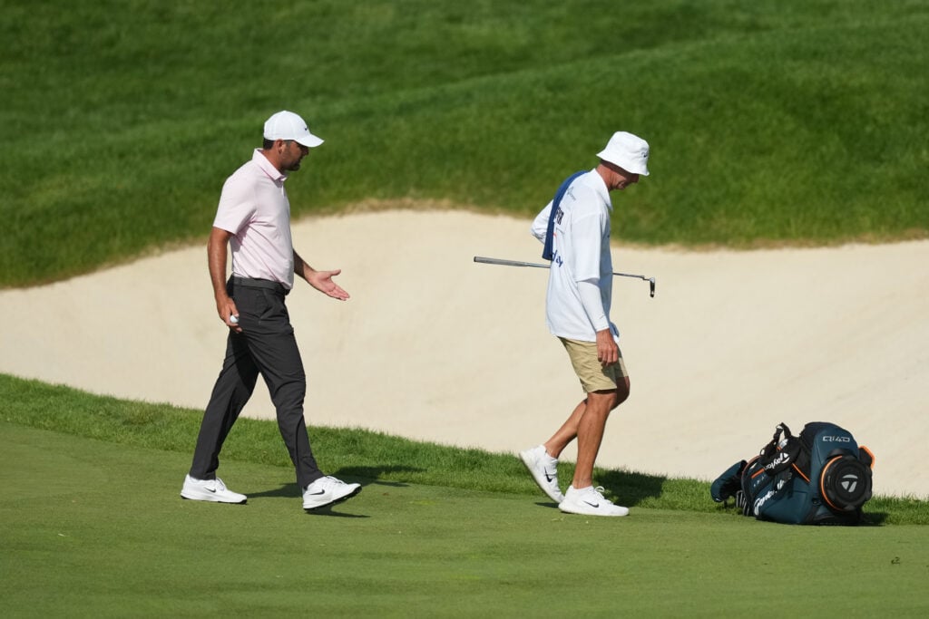 Scottie Scheffler speaks to Ted Scott during the first round of the Memorial Tournament