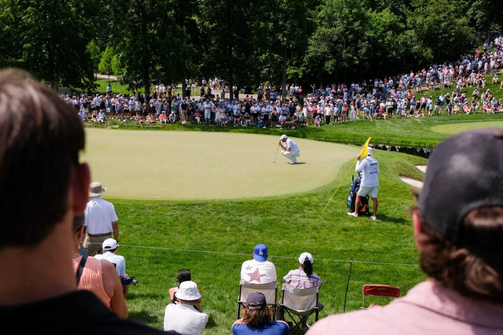 Scottie Scheffler lines up a putt during the third round of the Memorial Tournament