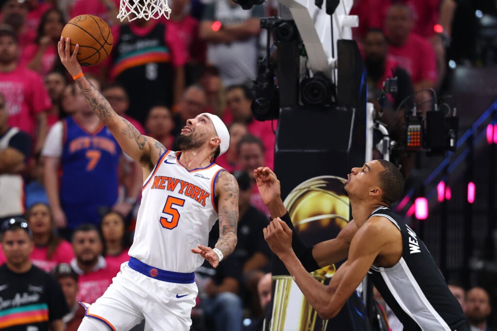 Jose Alvarado #5 of the New York Knicks shoots the ball against Victor Wembanyama #1 of the San Antonio Spurs during the second quarter in Game One of the 2026 NBA Finals at Frost Bank Center.