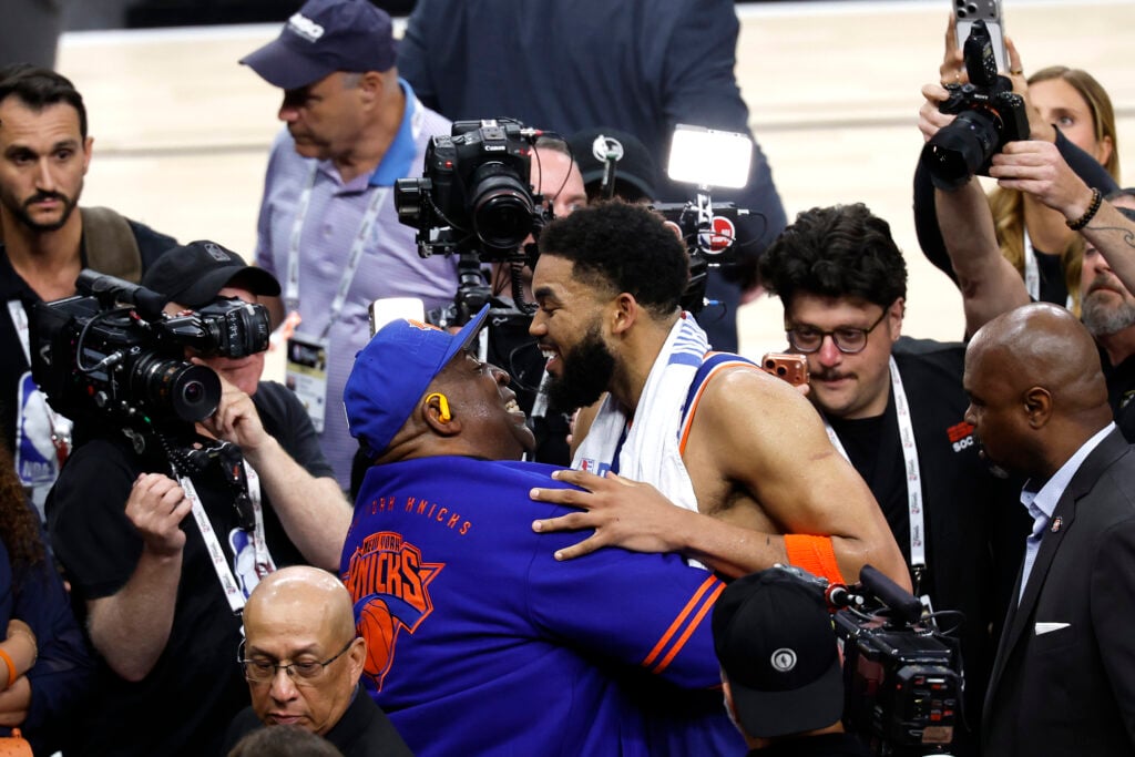 Karl-Anthony Towns #32 of the New York Knicks celebrates with his father Karl Towns Sr. after the 105-104 victory against the San Antonio Spurs in Game Two of the 2026 NBA Finals at Frost Bank Center.