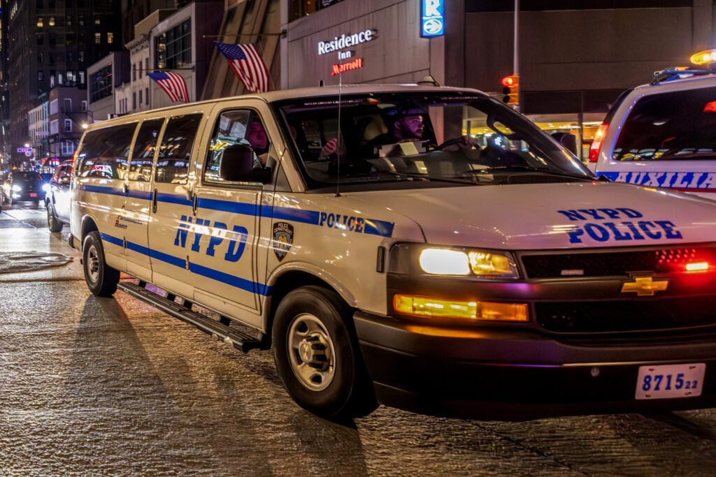 New York Police Department (NYPD) officers take security measures and intervene as rowdy New York Knicks fans gather to watch Game 3 of the NBA Finals against the San Antonio Spurs.