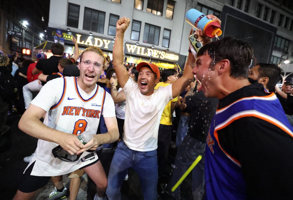 New York Knicks fans celebrate outside Madison Square Garden after their team's Game 4 victory over the San Antonio Spurs in the NBA Finals.