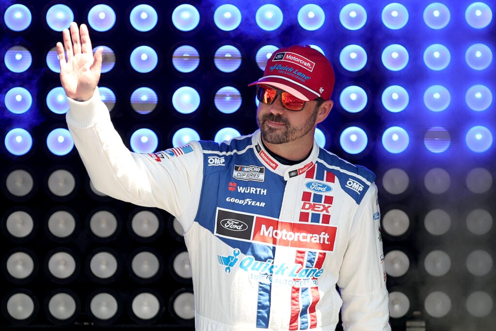 Josh Berry, driver of the #21 Motorcraft/Quick Lane Ford, waves to fans as he walks onstage during driver intros prior to the NASCAR Cup Series FireKeepers Casino 400 at Michigan International Speedway on June 07, 2026 in Brooklyn, Michigan.