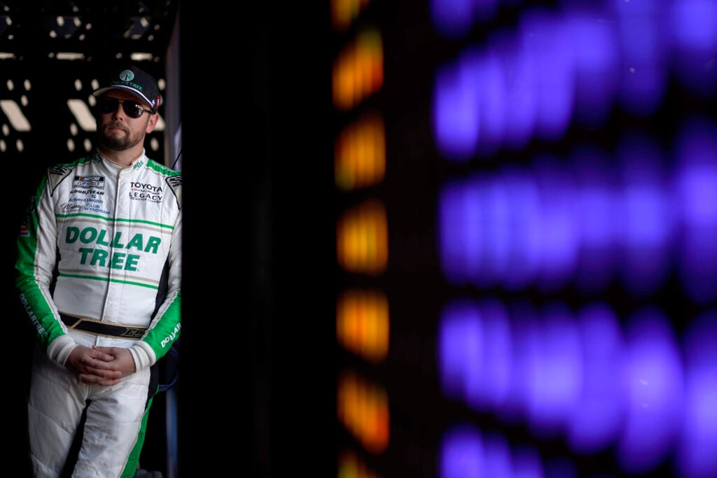 Erik Jones, driver of the #43 Dollar Tree Toyota, waits backstage during pre-race ceremonies prior to the NASCAR Cup Series FireKeepers Casino 400 at Michigan International Speedway on June 07, 2026 in Brooklyn, Michigan.