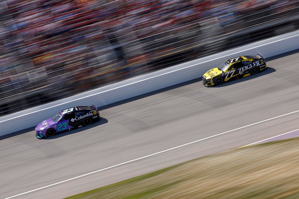 Bubba Wallace, driver of the #23 Columbia Toyota, and Carson Hocevar, driver of the #77 Zeigler Auto Group Chevrolet, race during the NASCAR Cup Series FireKeepers Casino 400 at Michigan International Speedway on June 07, 2026 in Brooklyn, Michigan.