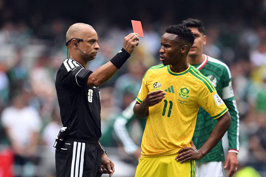 Brazilian referee Wilton Sampaio shows a red card to South Africa's midfielder #11 Themba Zwane during the 2026 World Cup Group A football match between Mexico and South Africa at the Mexico City Stadium.