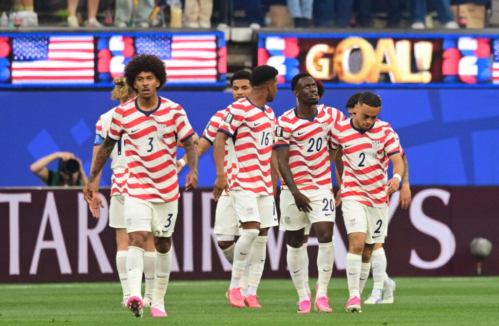 US defender #16 Alex Freeman, forward #20 Folarin Balogun and defender #02 Sergino Dest celebrate their team's first goal scored own goal by Paraguay's midfielder #16 Damian Bobadilla during the 2026 World Cup Group D football match between USA and Paraguay at the Los Angeles Stadium in Inglewood on June 12, 2026.