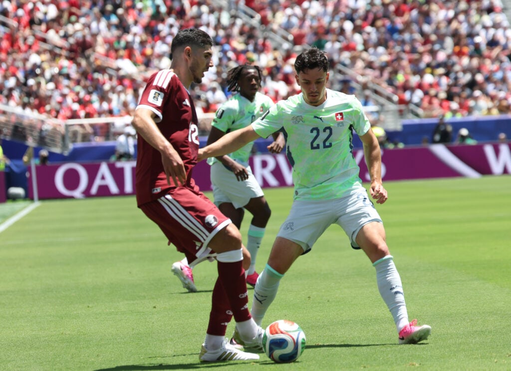 Fabian Rieder of Switzerland is challenged by Karim Boudiaf of Qatar during the FIFA World Cup 2026 Group B match between Qatar and Switzerland at San Francisco Bay Area Stadium in Santa Clara, California, on June 13, 2026.