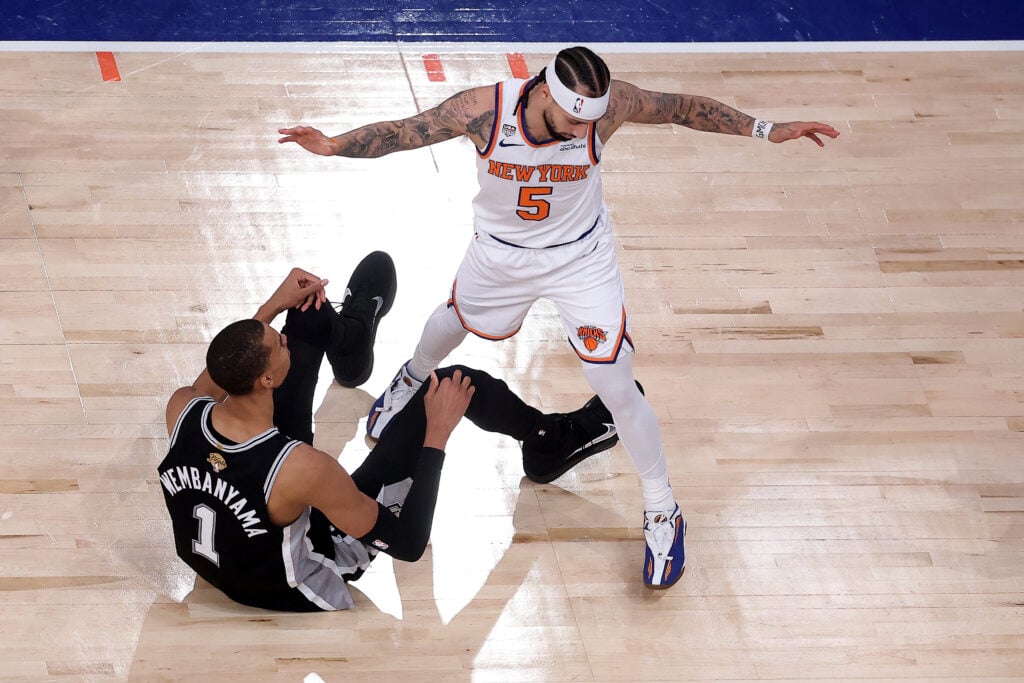 Victor Wembanyama #1 of the San Antonio Spurs is fouled by Jose Alvarado #5 of the New York Knicks during the second quarter in Game Four of the 2026 NBA Finals at Madison Square Garden.