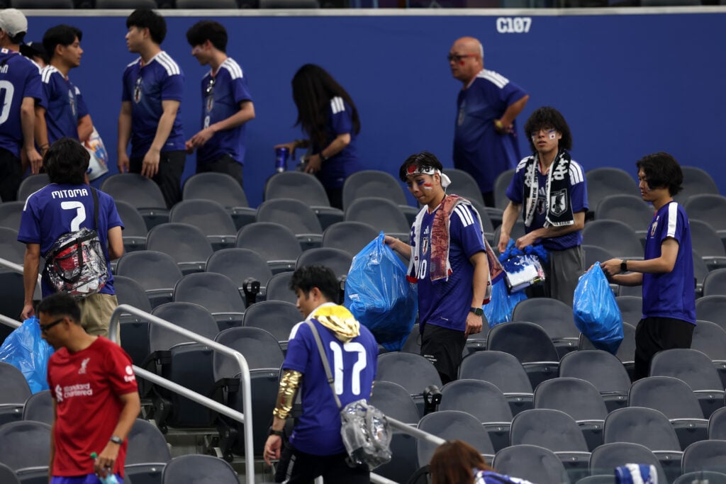 Japan fans clear trash in the stands during the FIFA World Cup 2026 Group F match between Netherlands and Japan at Dallas Stadium on June 14, 2026 in Arlington, Texas.