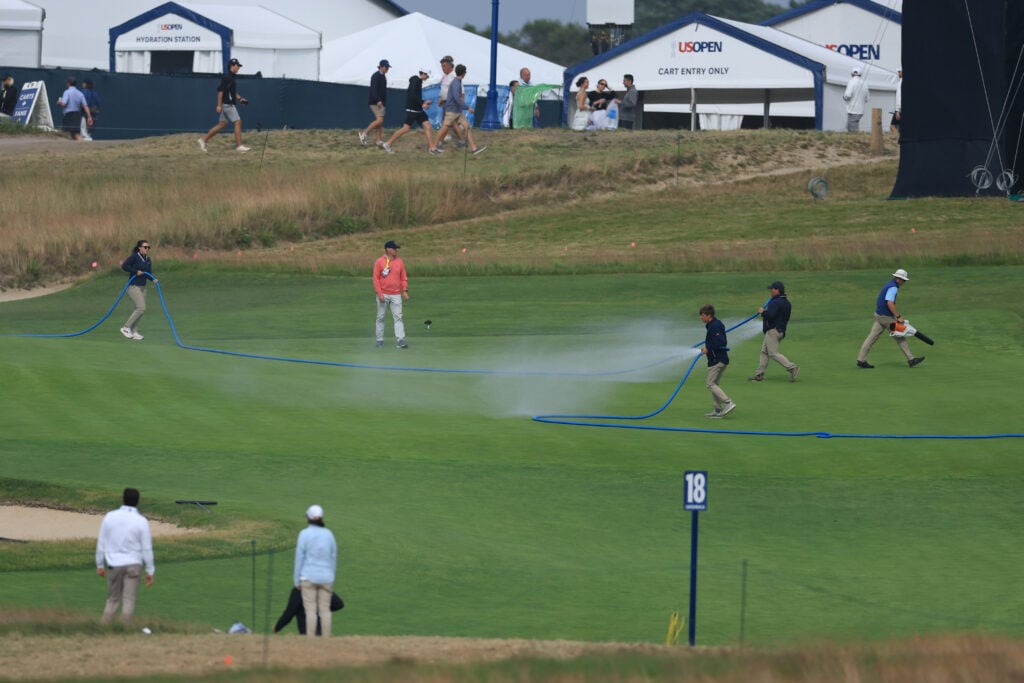 General View of greenkeepers watering the 18th hole during the first round of the 126th U.S. OPEN at Shinnecock Hills