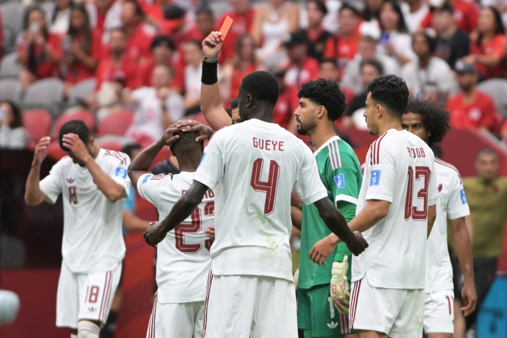 Assim Madibo of Qatar receives a red card from referee Cristian Marcelo Garay Reyes during the World Cup match between Canada v Qatar.