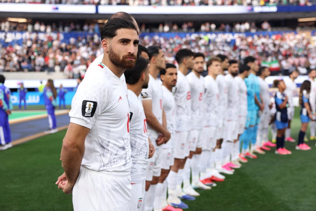 Alireza Jahanbakhsh #7 and players of IR Iran line up for the national anthem before the FIFA World Cup 2026 Group G match between IR Iran and New Zealand at Los Angeles Stadium.