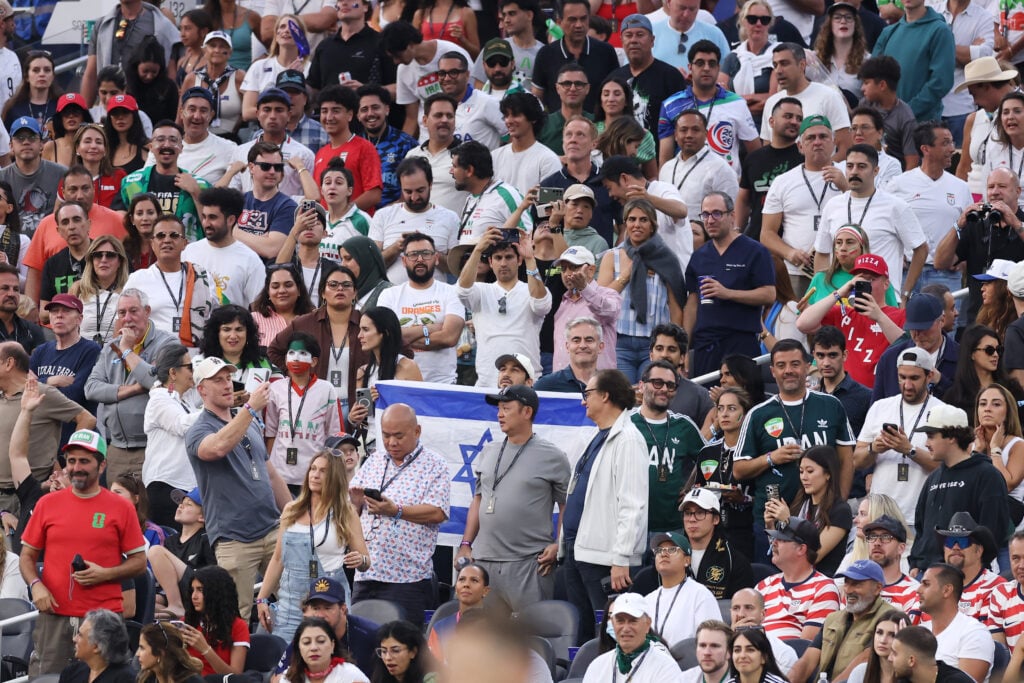 A fan displays the national flag of Israel in the stand during the FIFA World Cup 2026 Group G match between IR Iran and New Zealand