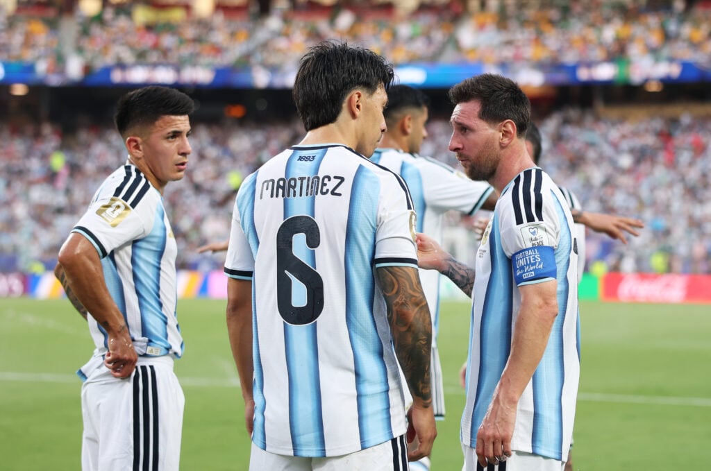 Lionel Messi #10 of Argentina talks to Thiago Almada #16 and Lisandro Martinez #6 of Argentina at the hydration break during the FIFA World Cup 2026 Group J match between Argentina and Algeria at Kansas City Stadium on June 16, 2026 in Kansas City, Missouri.