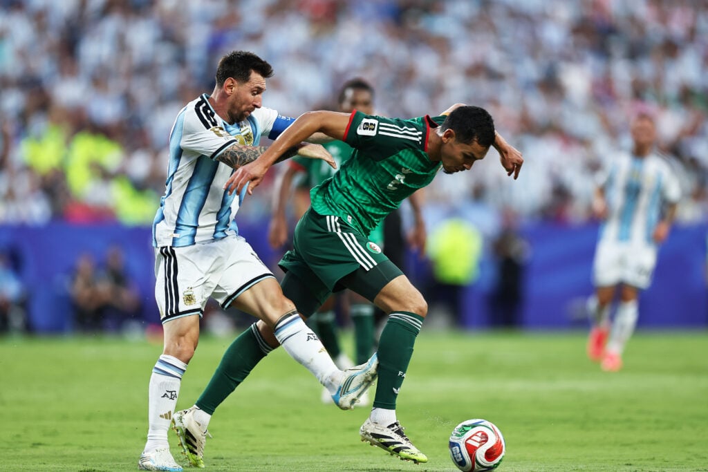 Aïssa Mandi #2 of Algeria is marked by Lionel Messi #10 of Argentina during the FIFA World Cup 2026 Group J match between Argentina and Algeria at Kansas City Stadium.