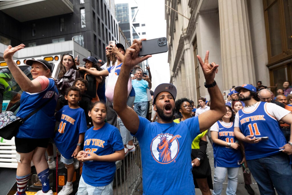 Fans cheer for the New York Knicks during the Knicks Championship ticker tape parade and victory rally celebrating winning the 2026 NBA Finals.