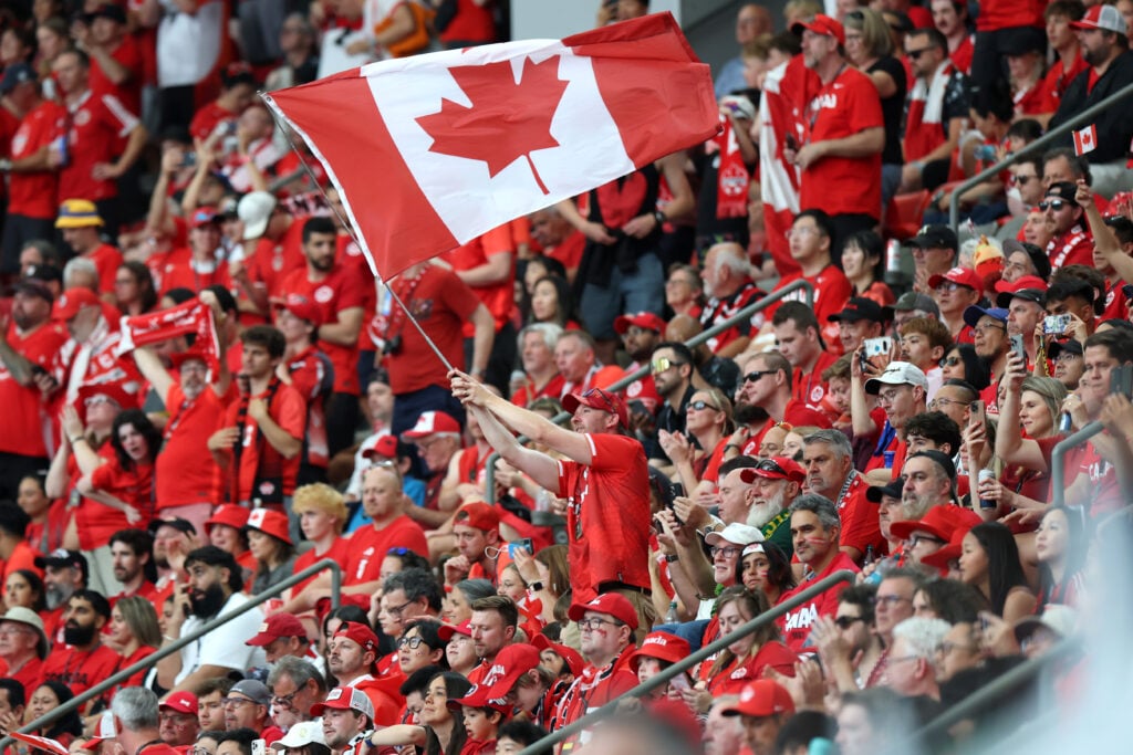 A fan of Canada waves a flag before the FIFA World Cup 2026 Group B match between Canada and Qatar at BC Place Vancouver