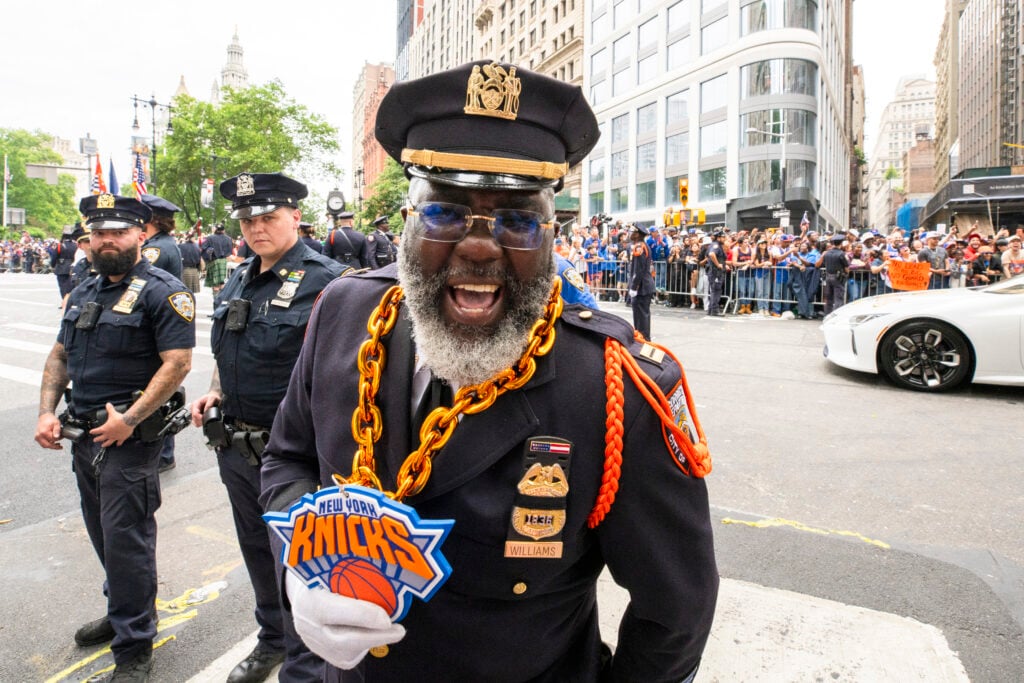 A Police Officer celebrates during the New York Knicks Championship ticker tape parade and victory rally celebrating winning the 2026 NBA Finals.