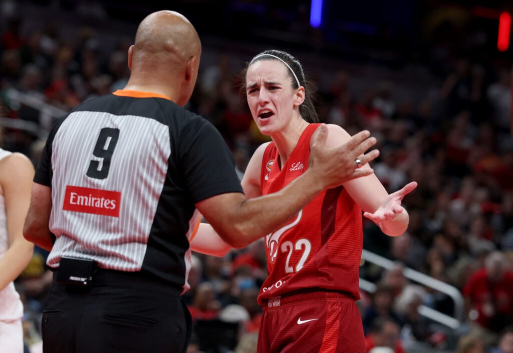 Caitlin Clark #22 of the Indiana Fever has words with a game official after being charged with a foul against the Atlanta Dream at Gainbridge Fieldhouse.
