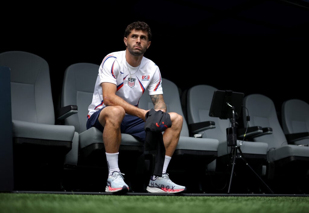 Christian Pulisic #10 of the United States looks on from the substitutes bench as his side warm up before the FIFA World Cup 2026 Group D match between USA and Australia at Seattle Stadium