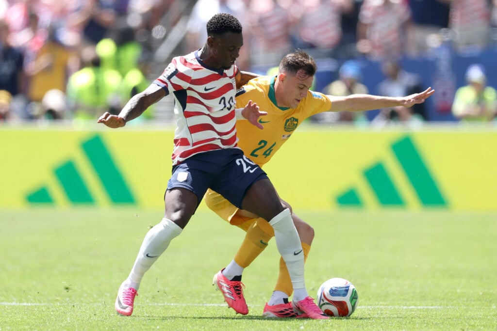 Paul Okon-Engstler #24 of Australia and Folarin Balogun #20 of the United States compete for the ball during the FIFA World Cup 2026 Group D match between USA and Australia at Seattle Stadium