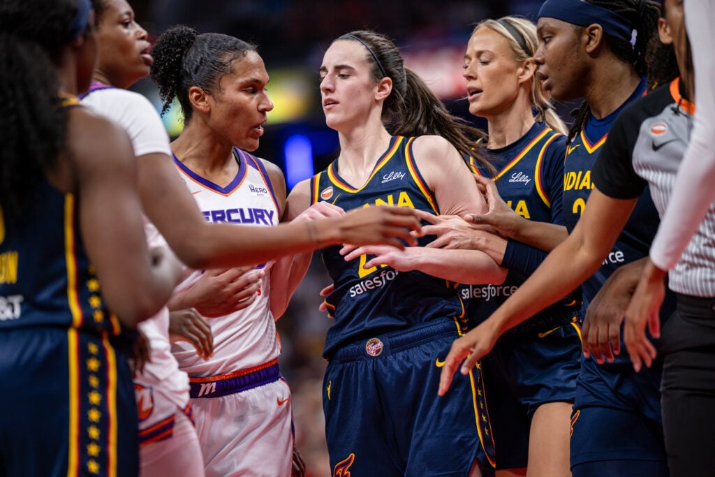 Alyssa Thomas #25 of the Phoenix Mercury and Caitlin Clark #22 of the Indiana Fever get into a scuffle during the game at Gainbridge Fieldhouse.