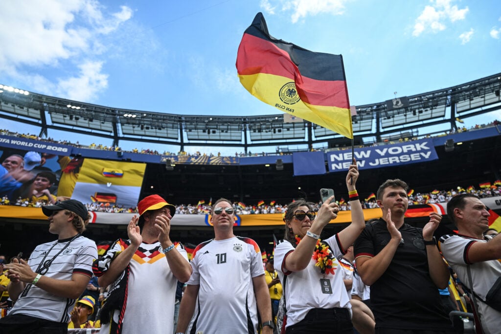 A German fan waves a flag cheering for her team ahead of the 2026 World Cup Group E football match between Ecuador and Germany
