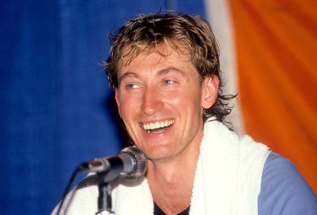 Wayne Gretzky #99 of the Los Angeles Kings talks to the media after he scored his 1851st career NHL point against the Edmonton Oilers on October 15, 1989 at the Northlands Coliseum.