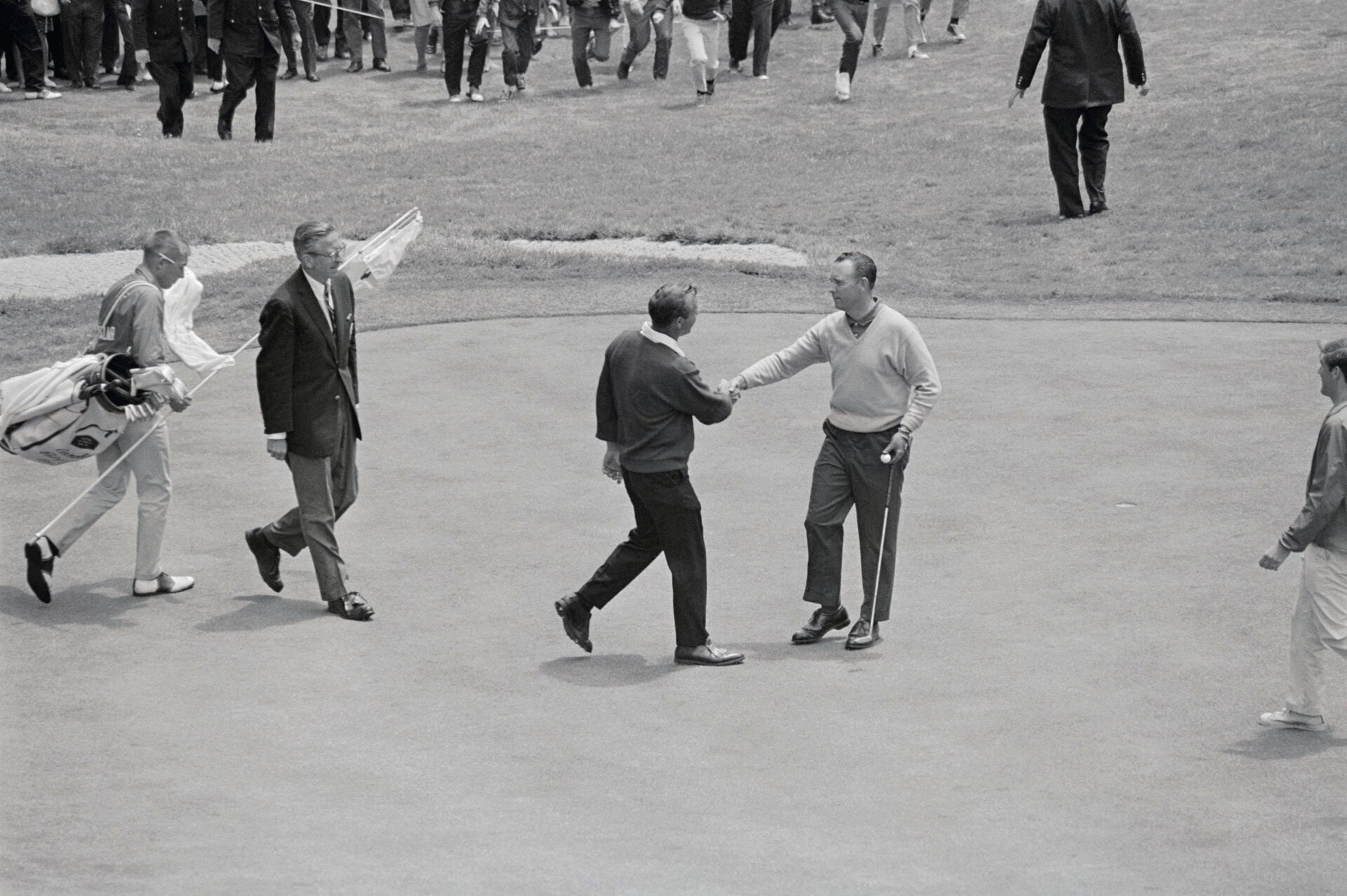 (Original Caption) Arnold Palmer congratulating his opponent, Billy Casper (right) just after the latter sank his final putt on the 18th green, to ...