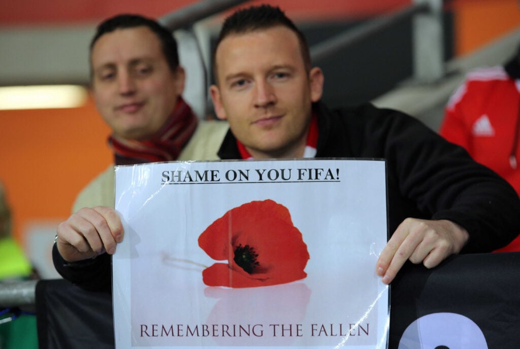 England fan displays poppy at World Cup in FIFA protest