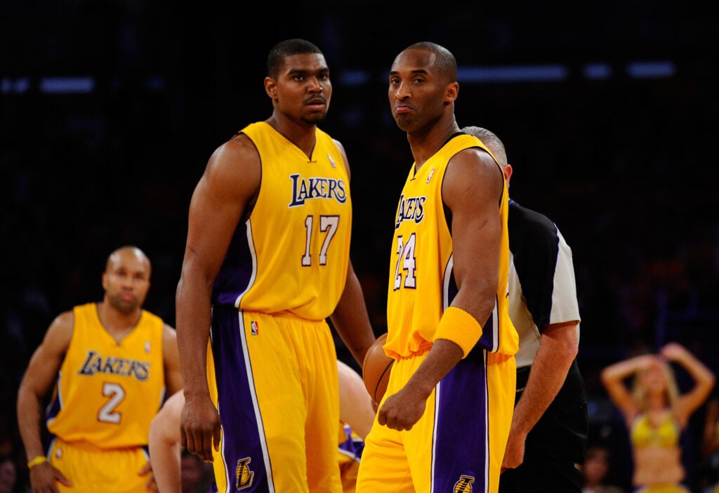 Andrew Bynum #17 and Kobe Bryant #24 of the Los Angeles Lakers stand on the court before taking on the Dallas Mavericks in Game One of the Western Conference Semifinals in the 2011 NBA Playoffs at Staples Center.