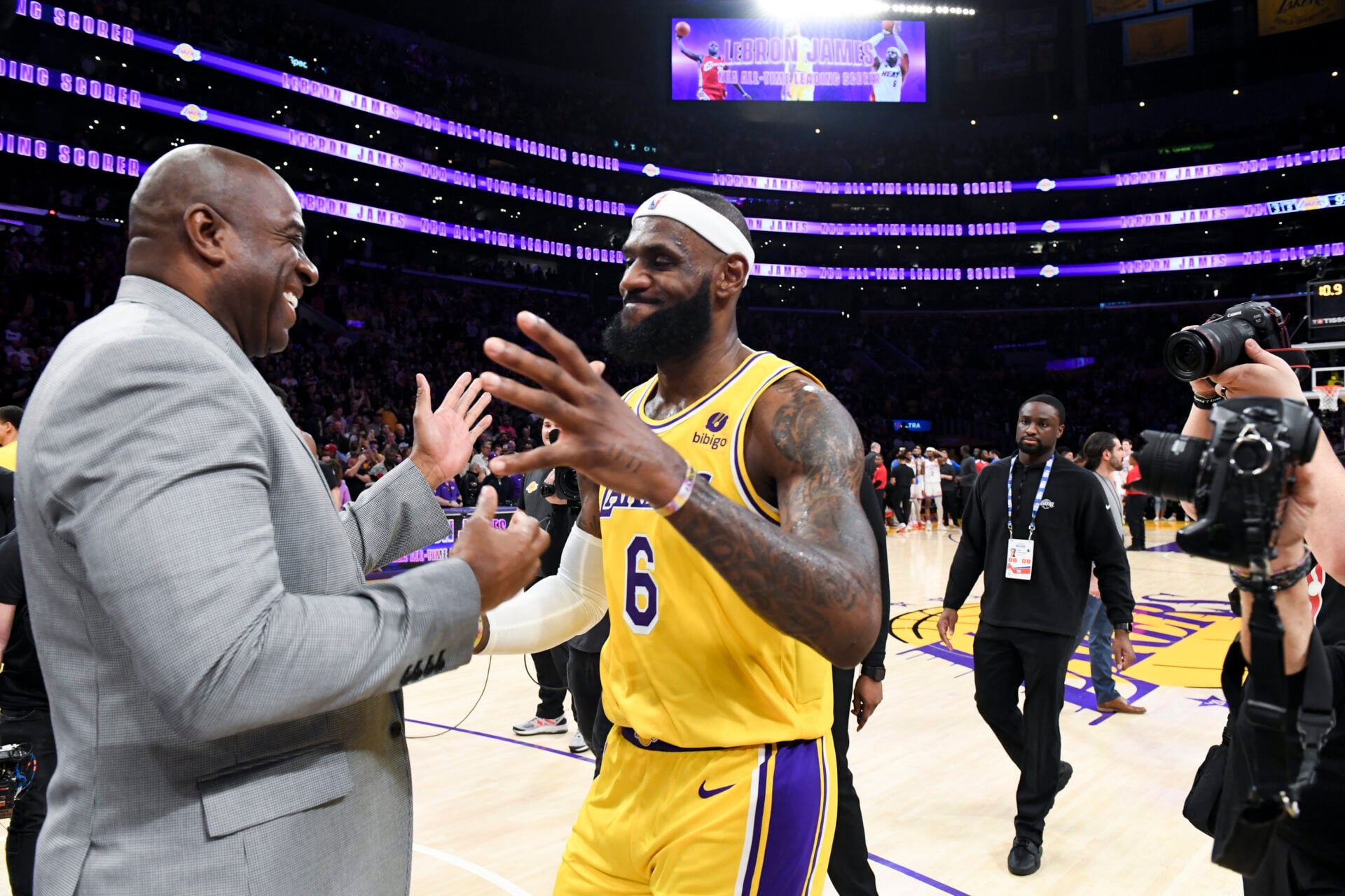 LOS ANGELES, CA - APRIL 29: LeBron James, right, hugs Magic Johnson after he passes Kareem Abdul-Jabbar to become the all-time NBA scoring leader, ...