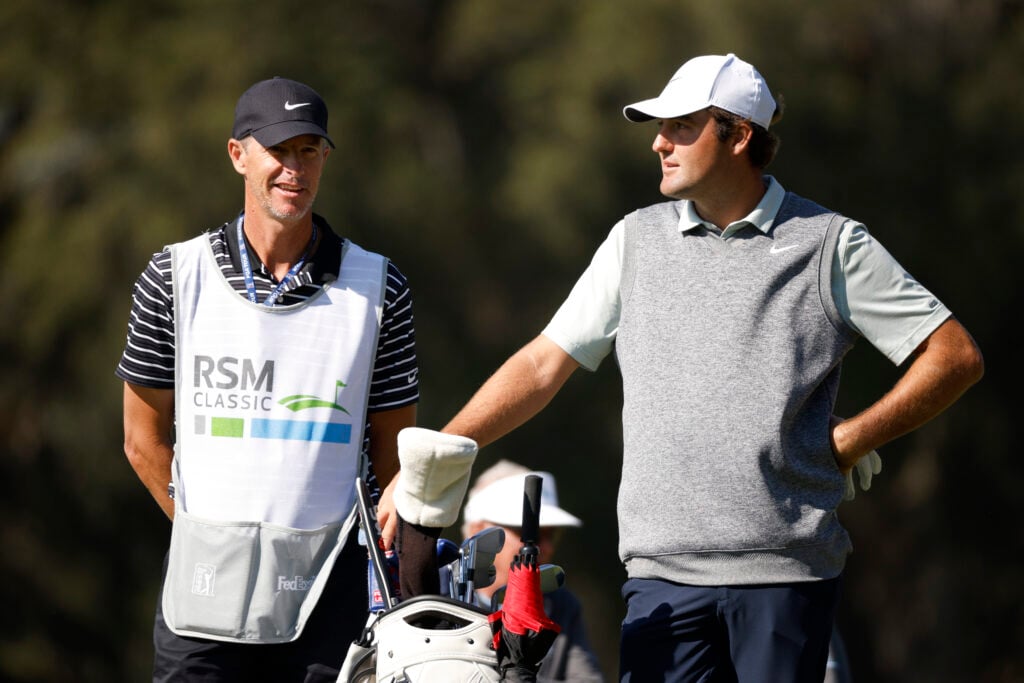 Scottie Scheffler speaks with Ted Scott during the RSM Classic in 2021