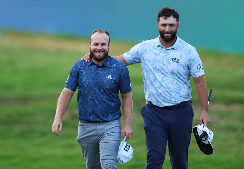 Tyrrell Hatton of England and Jon Rahm of Spain embrace on the 18th green during Day One of the BMW PGA Championship at Wentworth Golf Club