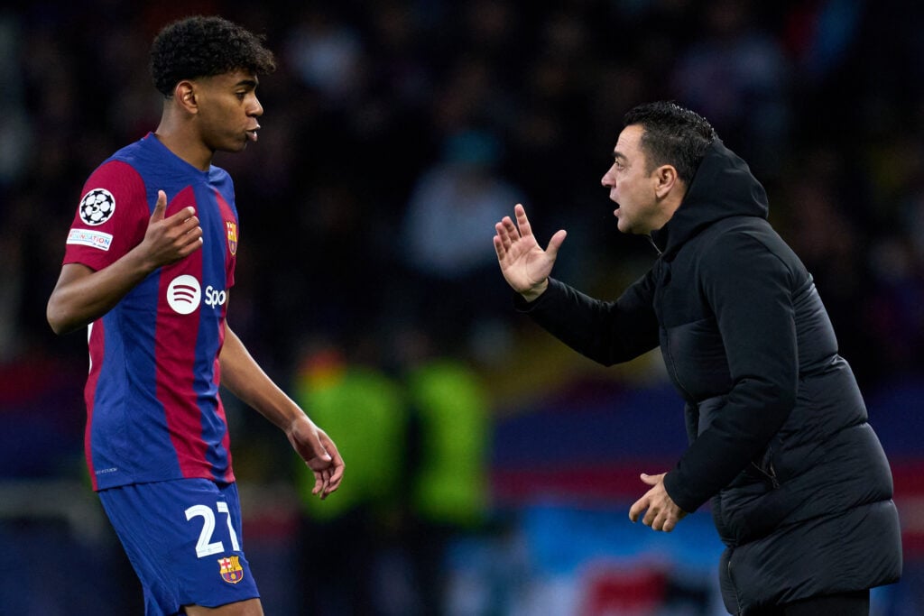 FC Barcelona Head Coach Xavi Hernandez interacts with Lamine Yamal of FC Barcelona during the UEFA Champions League 2023/24 round of 16 second leg match between FC Barcelona and SSC Napoli at Estadi Olimpic Lluis Companys on March 12, 2024 in Barcelona, Spain.