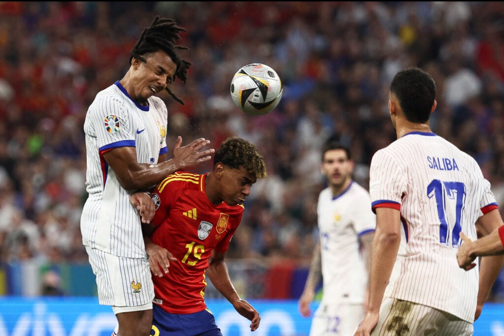 France's defender #05 Jules Kounde (up) fights for the ball with Spain's forward #19 Lamine Yamal during the UEFA Euro 2024 semi-final football match between Spain and France at the Munich Football Arena in Munich on July 9, 2024.